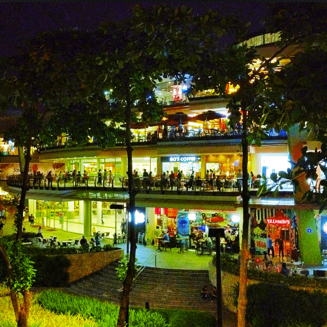 A busy, multiple-level mall filed with people at night.