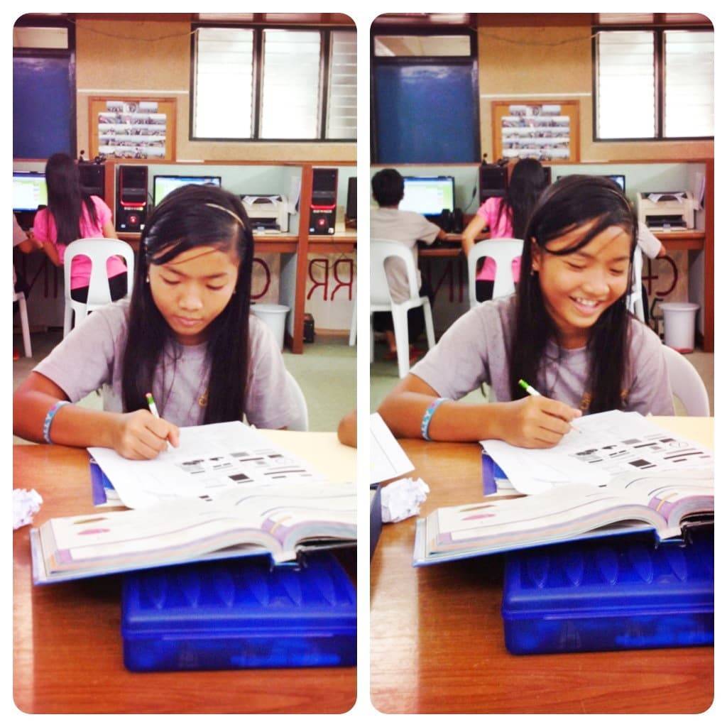 Young girl writing in a workbook.