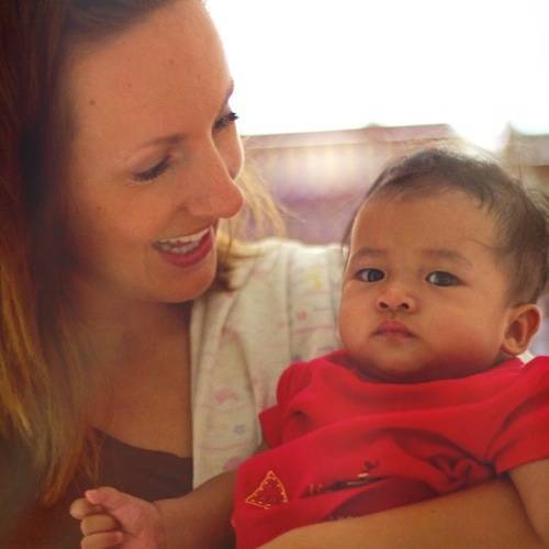 Lindsay holding a baby at CSC.