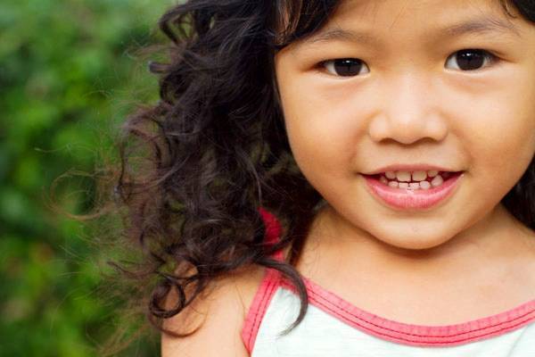 Young girl smiling at the camera.