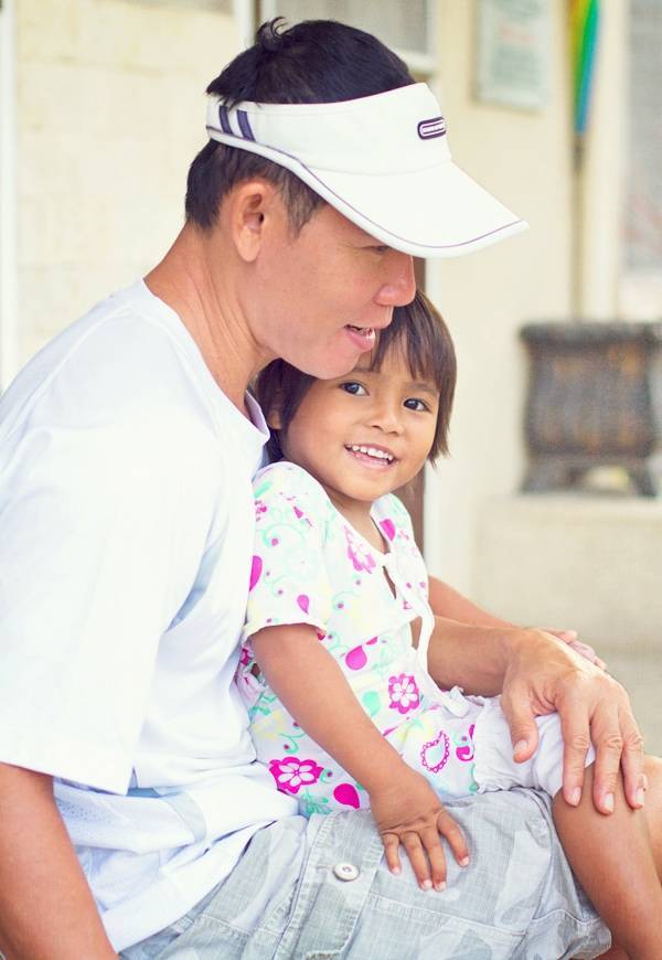 Man holding a young girl.
