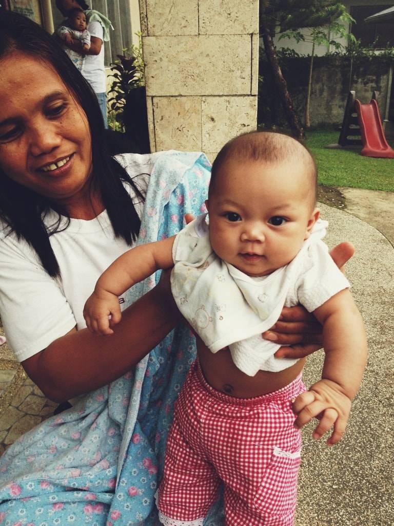 Woman holding a baby.