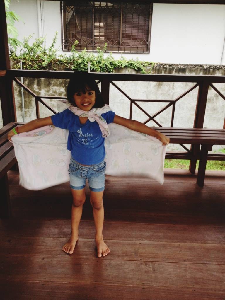 Child wearing a play cape.