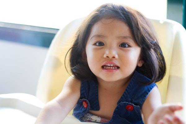 Young girl reaching for the camera.