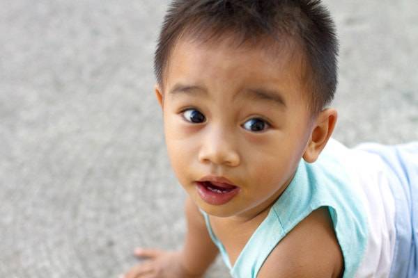 Infant boy looking at camera.