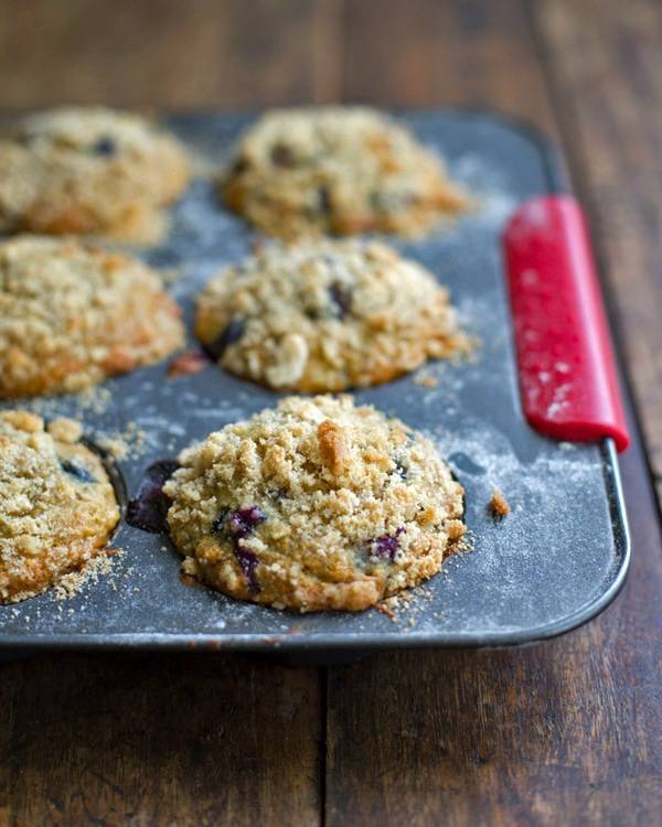 Oatmeal flax blueberry muffins in a muffin tin.