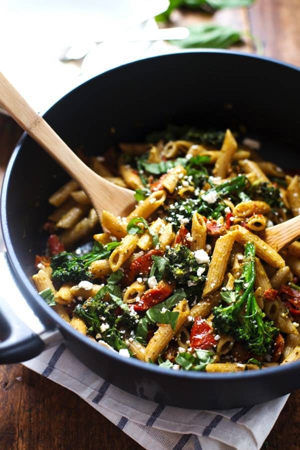 Lemon Pesto Penne in a pan with a wooden spoon.