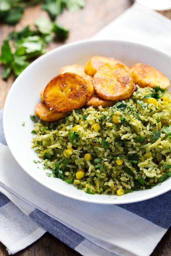 Green Mexican Rice with Corn in a white bowl.
