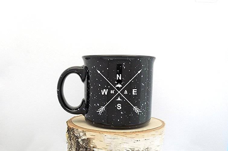 A cup with the directions of N,S, E, and W on it.