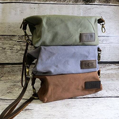 Bag with the leather belt and a latch and the sticker imprinted in the bag.