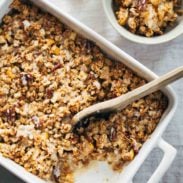 Coconut Oil Apple Crisp in a pan with a wooden spoon.