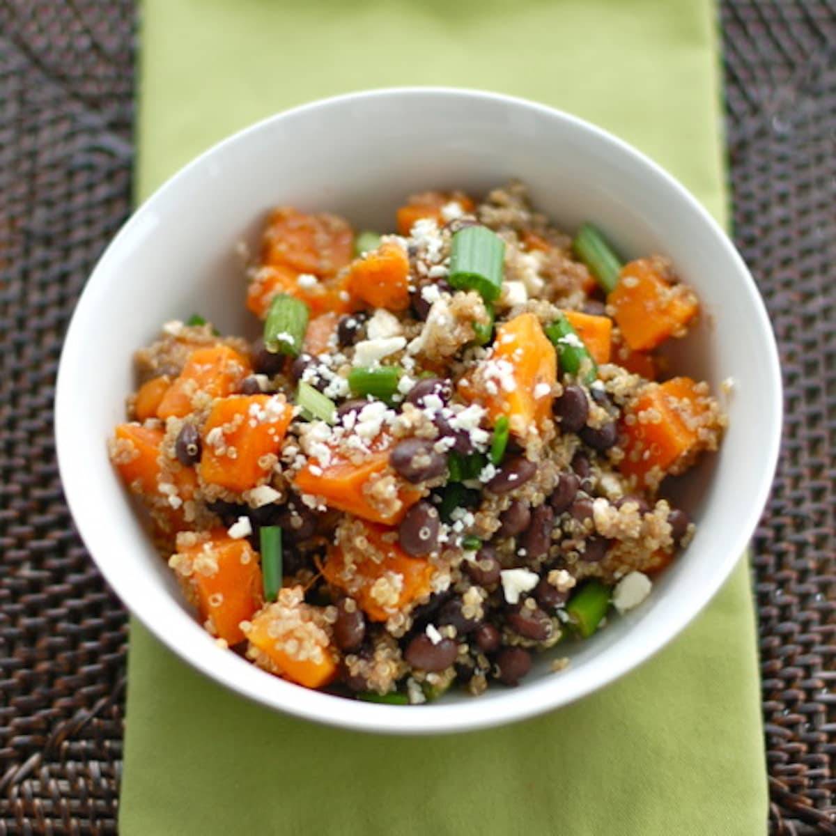 Butternut squash black bean wrap dissembled in a bowl on a green napkin.