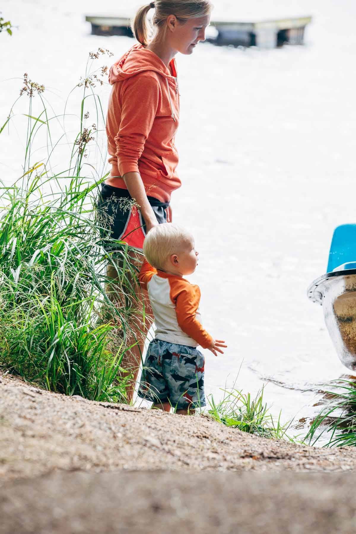 Woman holding the hand of a little boy.