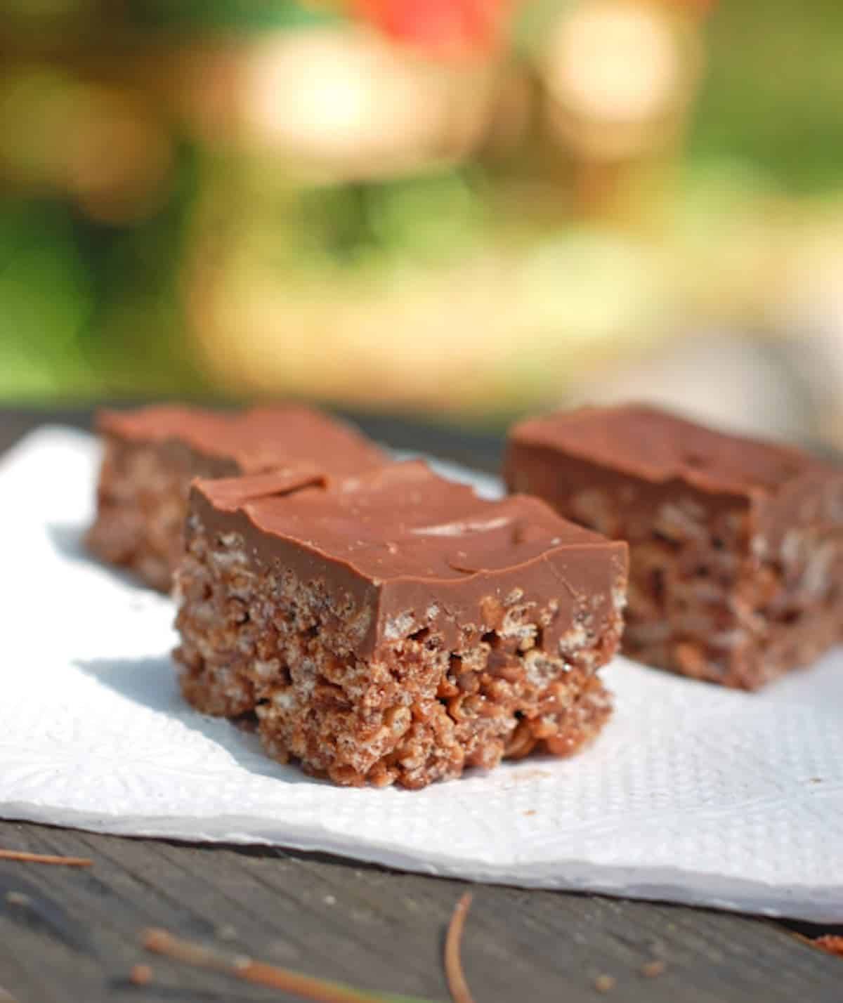 Chocolate scotcheroos on a napkin.