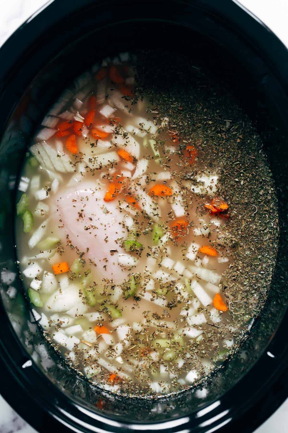 Ingredients for Crockpot Chicken Gnocchi Soup in a crockpot.