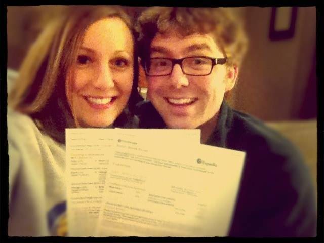 Man and woman holding plane tickets.