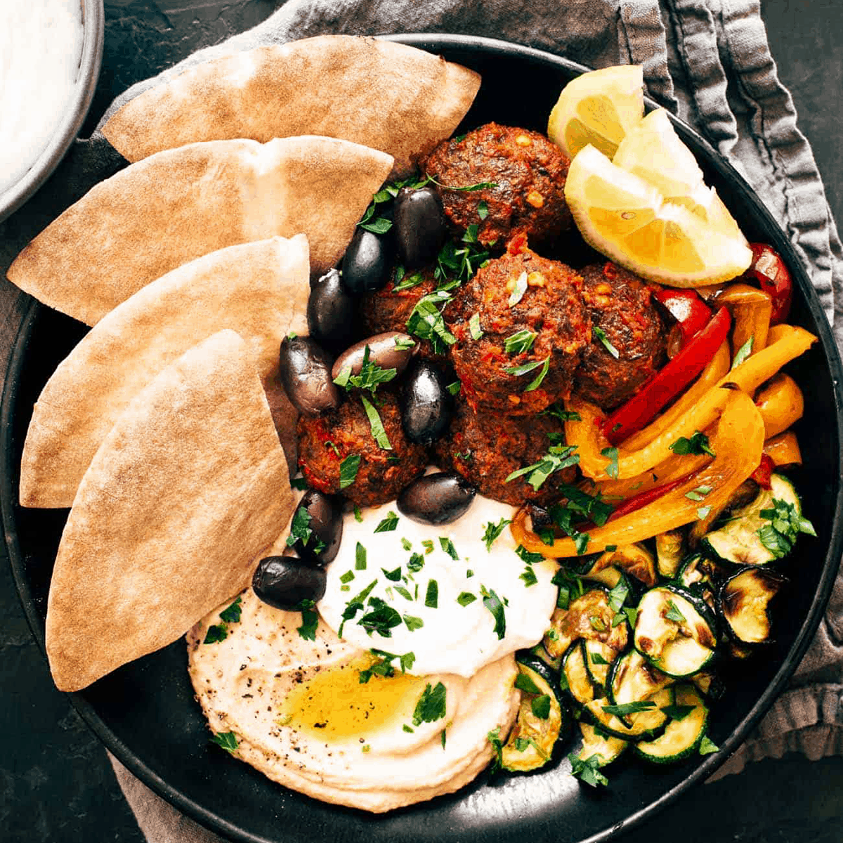 Harissa meatballs in a bowl with whipped feta.