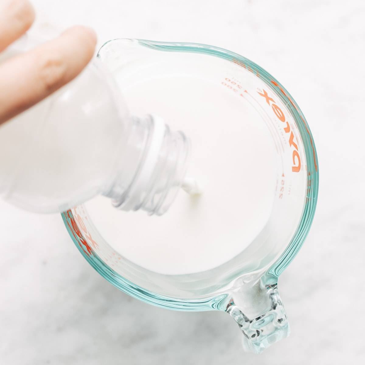 Pouring milk into glass.