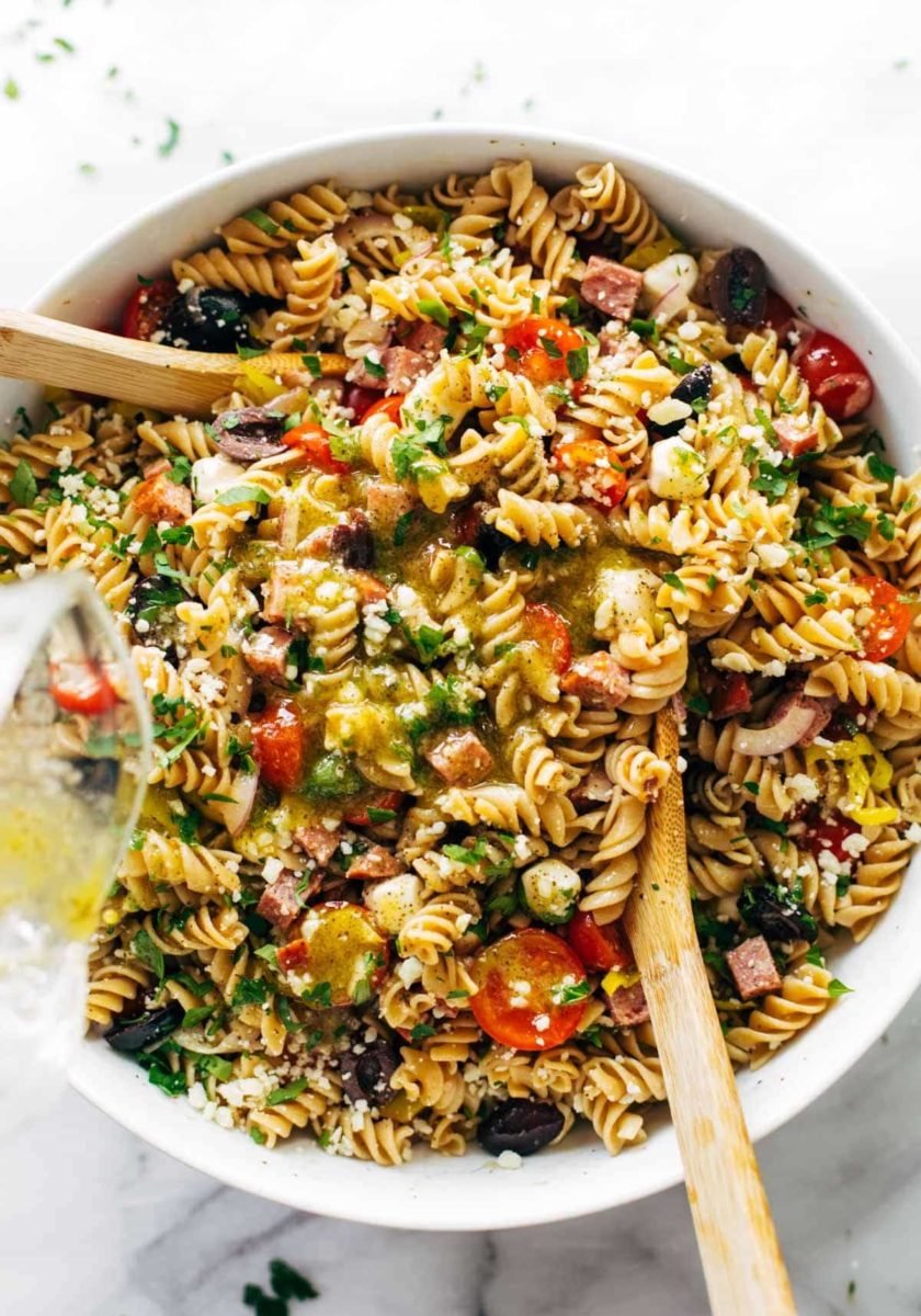 Pasta salad in bowl with spoons.