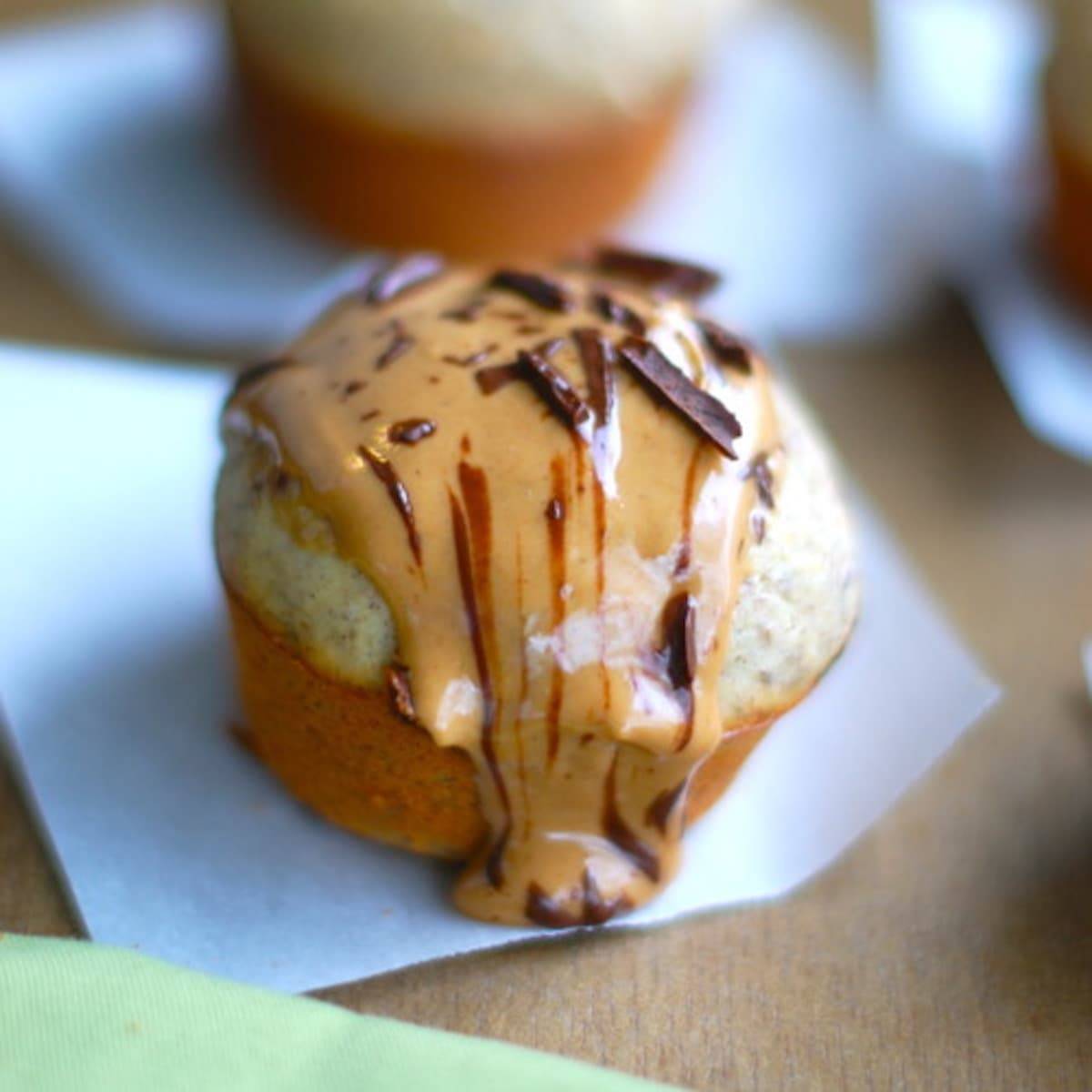 Peanut butter banana flax muffin on a piece of parchment paper.