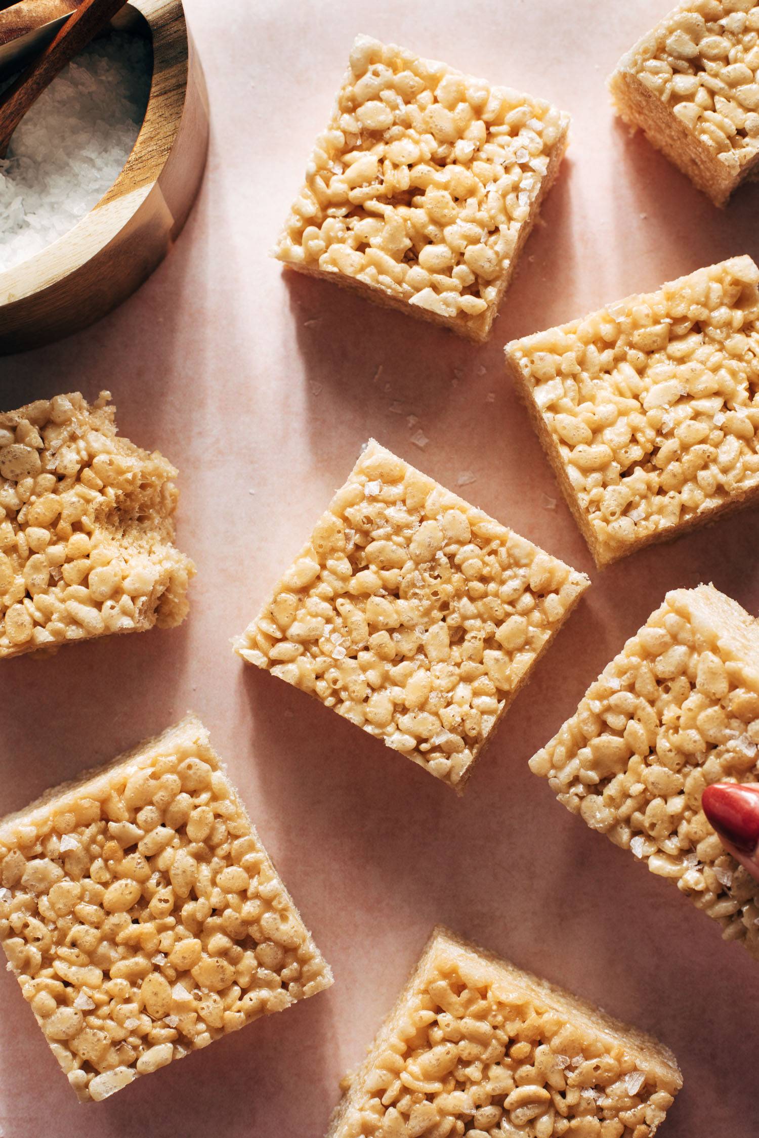 Hand grabbing cut rice krispie bars