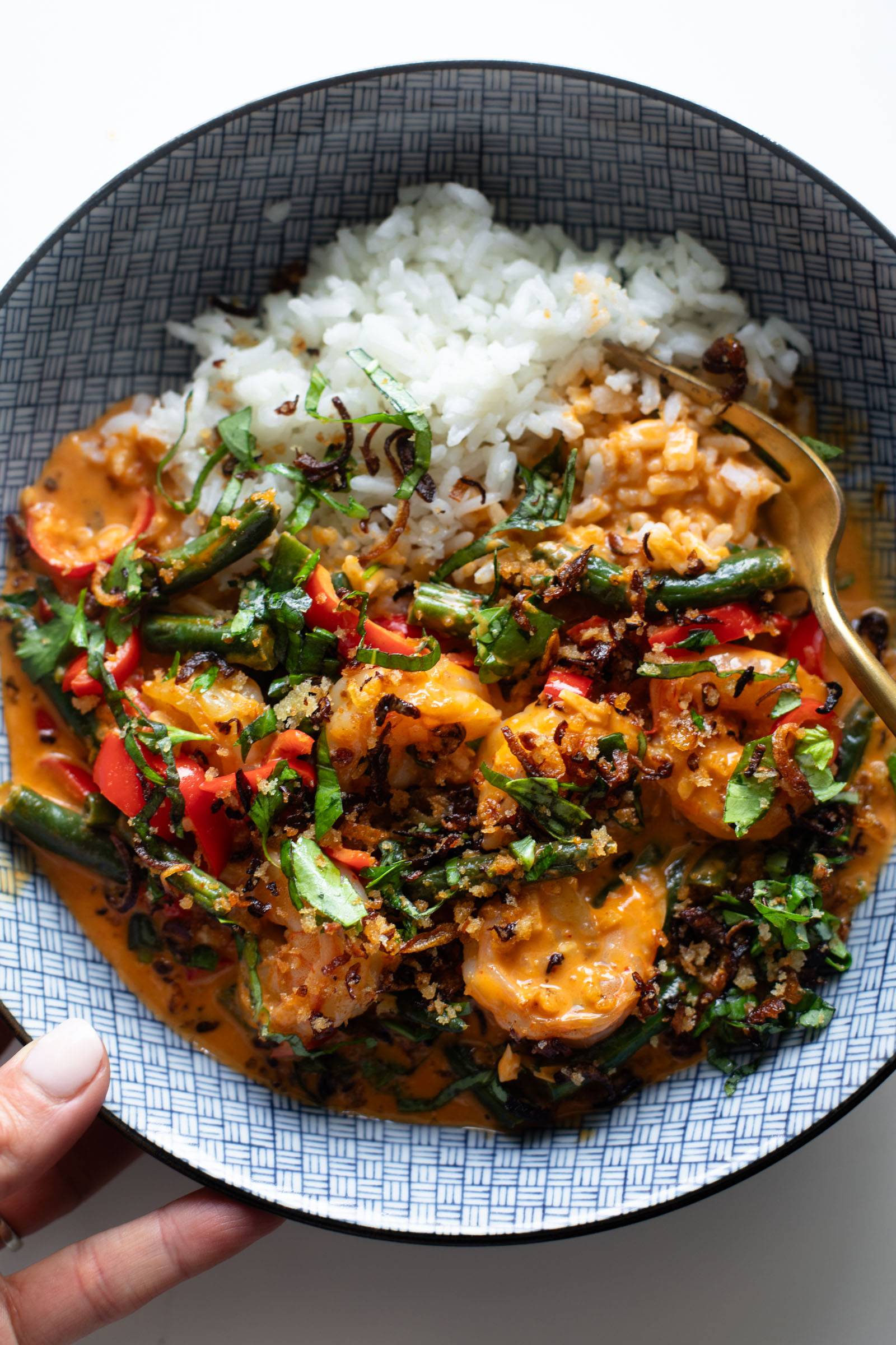 Shrimp curry in a bowl with rice.