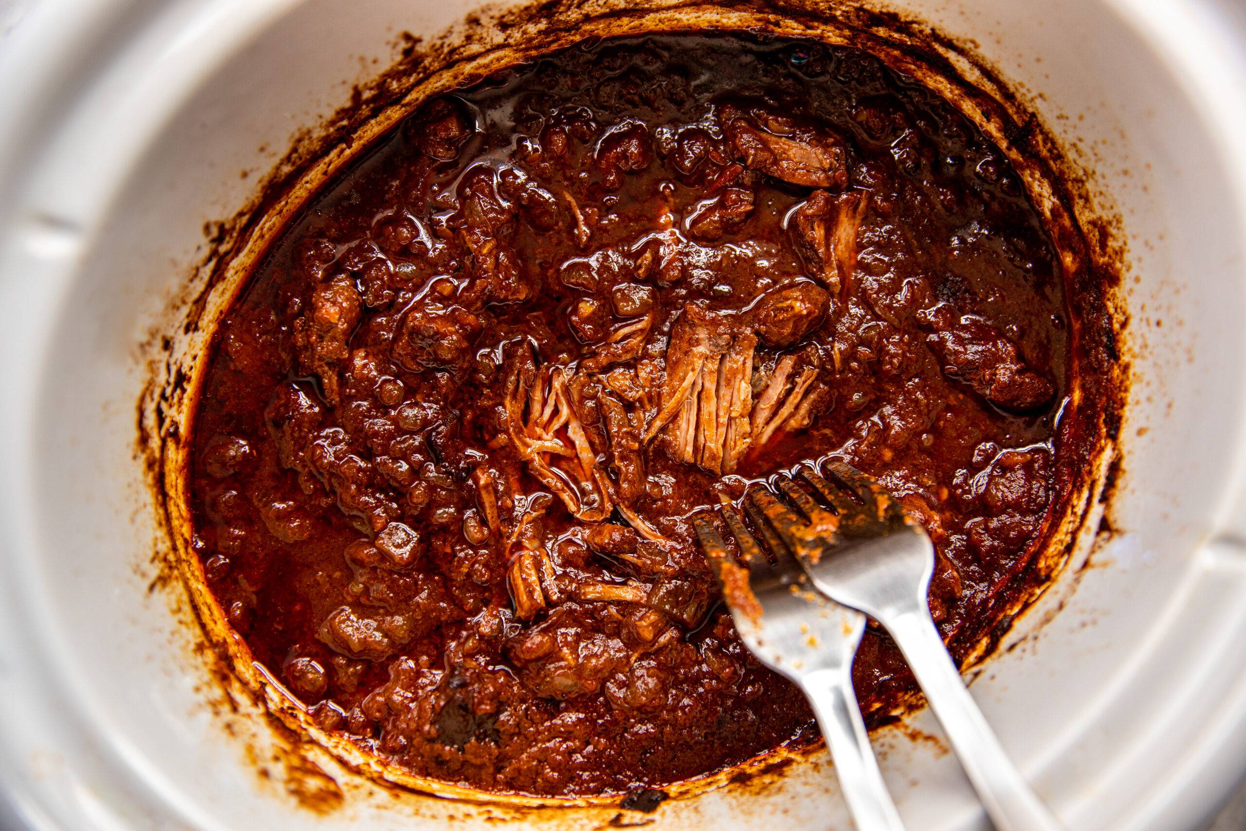 Shredding beef in a slow cooker.