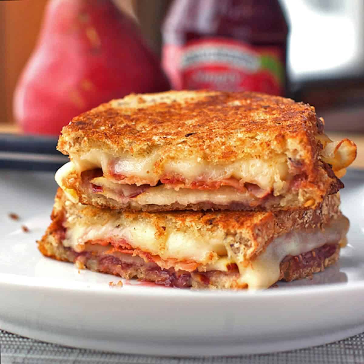 Grilled cheese sandwich stuffed with bacon, pear slices, and raspberry preserves.