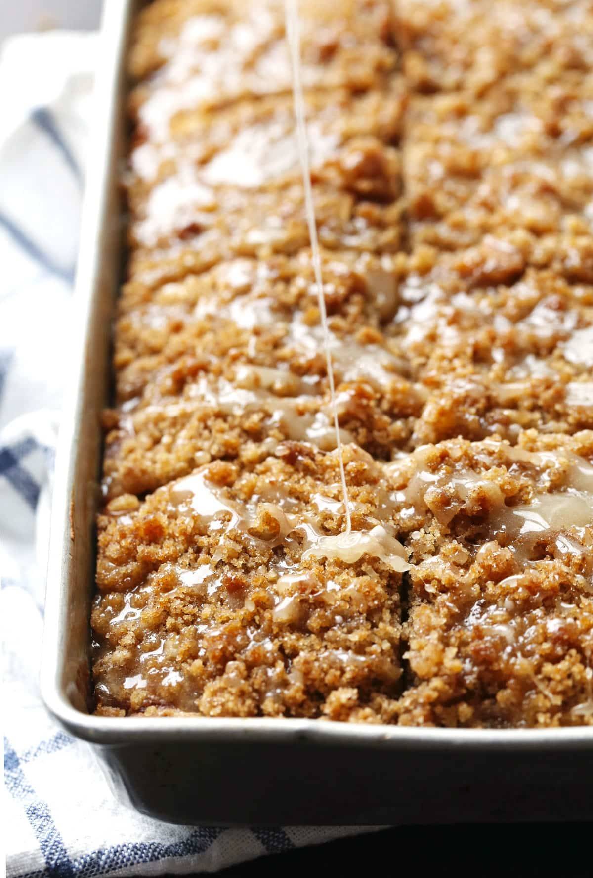 Cinnamon Streusel Pumpkin Coffee Cake with Maple Glaze in a dish.